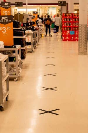 Sydney, Australia 2020-04-08 COVID-19. X marks on the floor at Kmart supermarket to keep social distancing in lines to the cashiersのeditorial素材