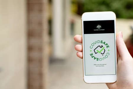 Sydney, Australia 2020-04-26 Hand holding a phone with CovidSafe app. Australian Government...