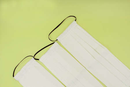 DIY Handmade eco friendly reusable white cotton face mask helps to stop the spread of the viruses. COVID-19 pandemic conceptの写真素材