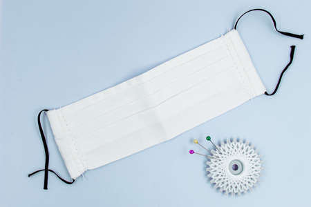 DIY Handmade eco friendly reusable white cotton face mask helps to stop the spread of the viruses. COVID-19 pandemic conceptの写真素材
