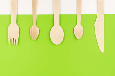 Eco friendly disposable cutlery utensils on green background. Bamboo wooden fork, knife and spoons. Zero waste conceptの写真素材