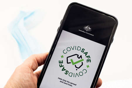 Sydney, Australia 2020-04-26 Hand holding a phone with CovidSafe app. Australian Government introduced new COVID-19 trace tracking appのeditorial素材