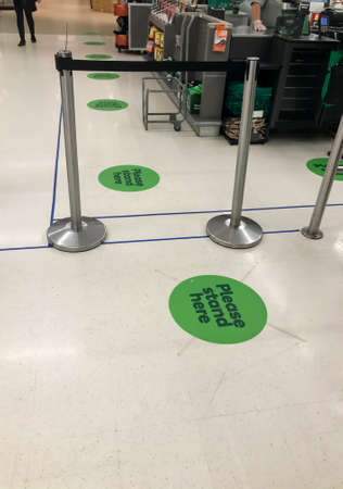 Sydney, Australia 2020-04 COVID-19. Stickers on the floor at Woolworths supermarket to keep social...