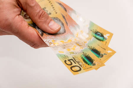 Hands holding australian dollars 50 banknotes. Finance and payment concept.