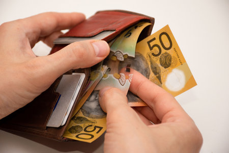 Hands holding leather wallet with australian dollars 50 banknotes. Finance and payment concept.の写真素材