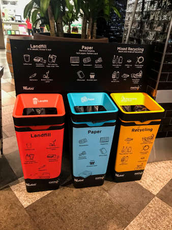 Sydney, Australia - 2020-09-13 New rubbish bins for paper, glass and general litter with educational poster of how to properly dispose various waste types at Westfield shopping centre.のeditorial素材