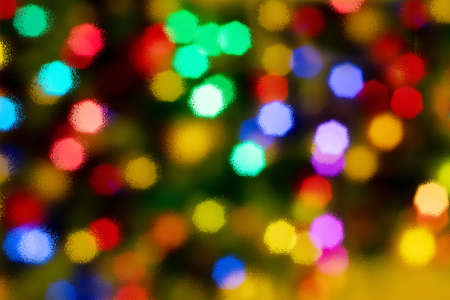 Abstract blurred disfocused Christmas lights background through wet glass.の写真素材