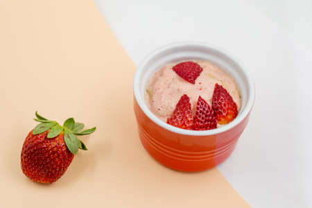 Banana nice cream with strawberries. Gluten free and dairy free healthy dessert. Blend frozen banana until smooth and add some strawberriesの写真素材