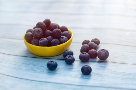 Superfood berries: blueberries in a bowl on a wooden background.の写真素材