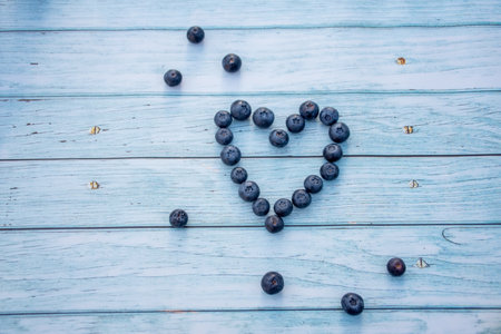 Superfood berries: blueberry heart on a wooden backgroundの写真素材