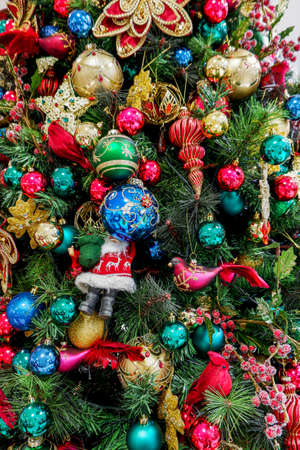 Vintage Christmas tree decorated with various toys and bubbles. Bright festive background
