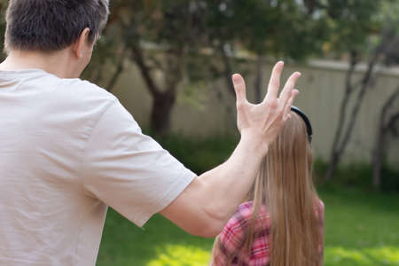 Problems between generations concept. Father argue with teenage daughter who is ignoring him. She...