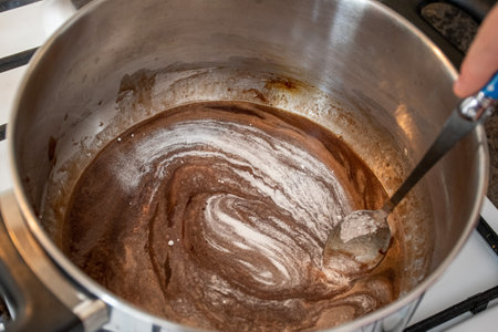 Do it yourself: Gingerbread cookies tutorial. Step by step recipe. Step 06. Remove from heat and add baking soda, mixture will foam up a bitの写真素材