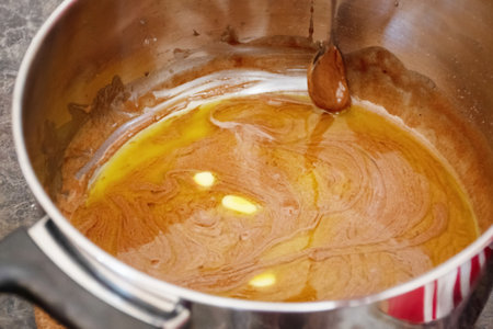 Do it yourself: Gingerbread cookies tutorial. Step by step recipe. Step 08. Stir in cold butter untill meltedの写真素材