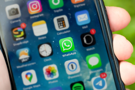 Sydney, Australia - 2021-01-17 Whatsapp messenger social networking logo app on the phone screen with other app logos blurred.のeditorial素材