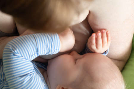 Caucasian mother breastfeeding a baby boy. Maternity love babycare family conceptの写真素材