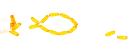 Omega-3 fish oil capsules in a shape of a fish. Vitamins and supplementsの写真素材