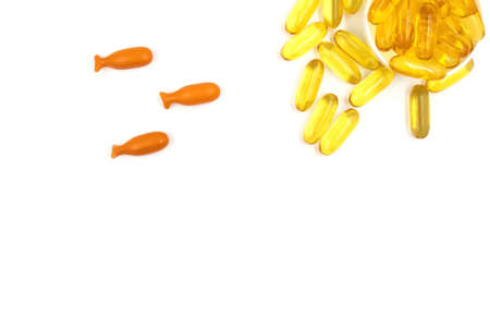 Omega-3 fish oil capsules on white background in a shape of a fish with copy space. Vitamins and supplementsの写真素材