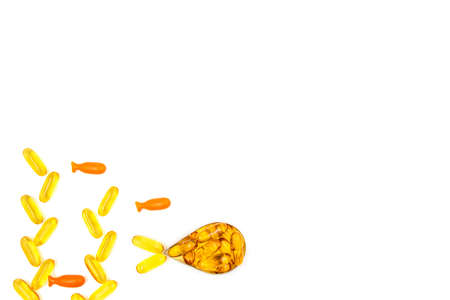 Omega-3 fish oil capsules in a shape of a fish on white background. Vitamins and supplementsの写真素材