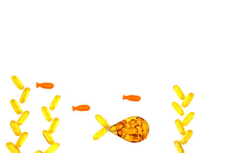 Omega-3 fish oil capsules in a shape of a fish on white background. Vitamins and supplementsの写真素材