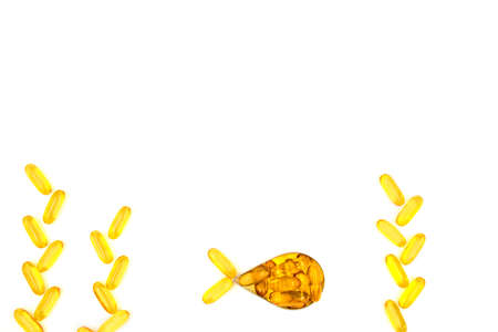 Omega-3 fish oil capsules in a shape of a fish on white background. Vitamins and supplementsの写真素材