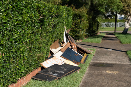 Household rubbish items put near the sidewalk for council waste collection. Illegal dumping. Garbage