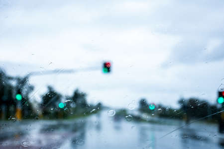 Blurred defocused image of the rain through the windscreen in Australia. Rain on the road backgroundの写真素材