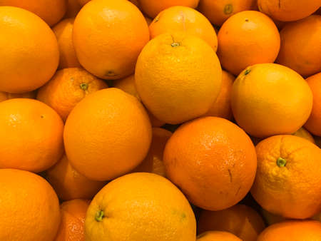 Oranges fruit piled on the market stall. Fruit shopping backgroundの写真素材