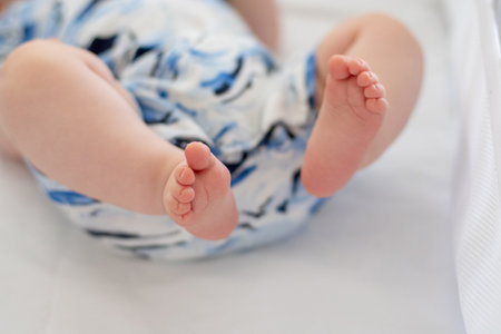 Sweet cute infant baby boy toes on a white blanket. Innocence and loveの写真素材