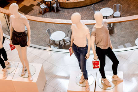 Mannequins wearing fashion clothes. Sale promotion of retail shop in shopping centreのeditorial素材