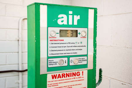 Air service for vehicle tires. Automatic inflator with pressure level indicator on 33 psi at gas station. Self service air compressorの写真素材