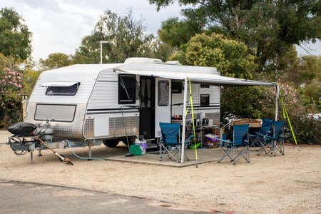 RV caravan camping on a campsite at the caravan park. Camping vacation travel conceptの写真素材