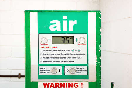 Air service for vehicle tires. Automatic inflator with pressure level indicator on 35 psi at gas station. Self service air compressorの写真素材
