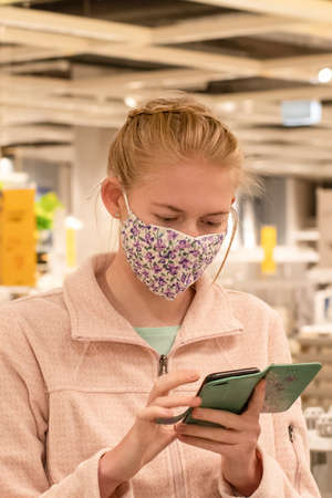 A girl wearing face mask in department store during pandemic. Mandatory face masks in NSW Australiaの写真素材