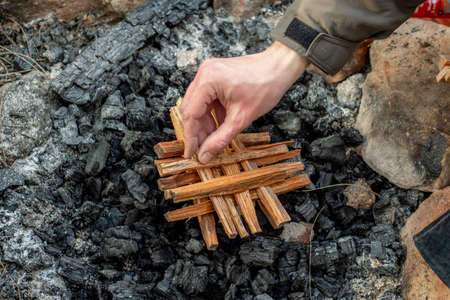 Starting the camp fire with kindling. Camping lifeの写真素材