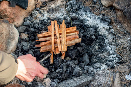 Starting the camp fire with kindling. Camping life