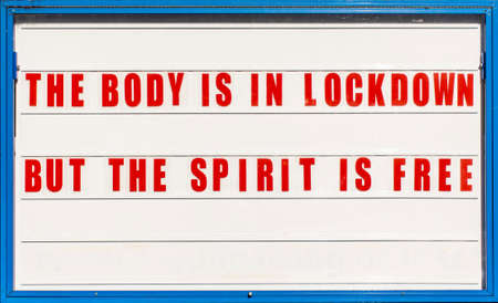 Churches are closed because of lockdown. Signboard with words The body is in lockdown but the spirit is free.の写真素材