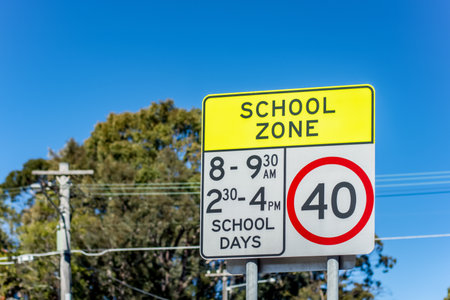 School zone road sign with speed limit 40 during before and after school hours in NSW, Australia. Road safety conceptの写真素材