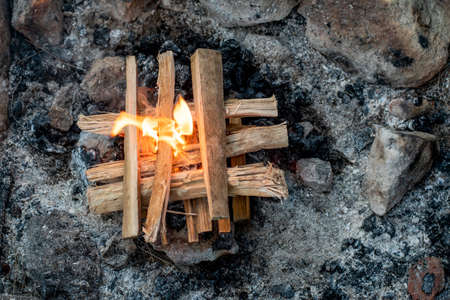 Starting the camp fire with kindling. Camping life