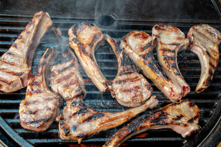 Lamb cutlets chops grilling on barbecue plate . Backyard BBQ grill cooking. Australia Day celebration party mealの写真素材