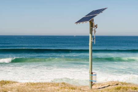 Solar energy panel photovoltaic cell on the pole near the ocean. Renewable energy. Enviroinment conservation and power saving. Solar powered equipment at Cronulla, NSW, Australiaの写真素材