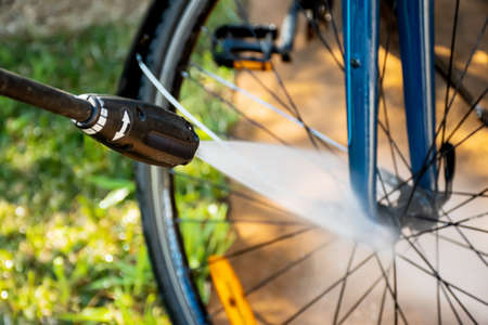 Cleaning washing a bilcycle wheels with pressure washer cleaner. Self service do it yourself bike maintenanceの写真素材