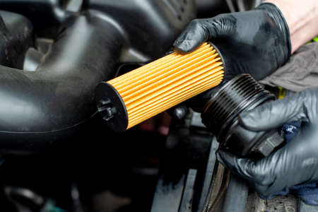 Changing car oil filter. DIY change engine motor oil. At home vehicle maintenance. Oil Filter replacement. New Oil filterの写真素材