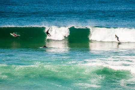 Surfers catching waves in the ocean at Cronulla, NSW, Australiaの写真素材
