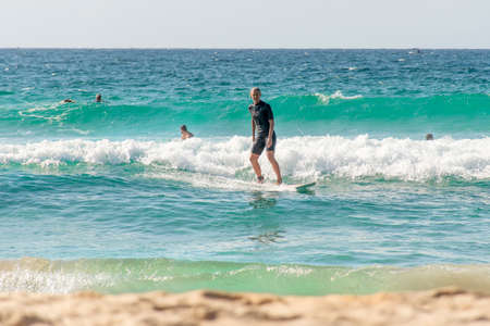 Sydney, Australia 2021-02-28 Surfers catching waves in the ocean at Cronulla, NSW, Australia