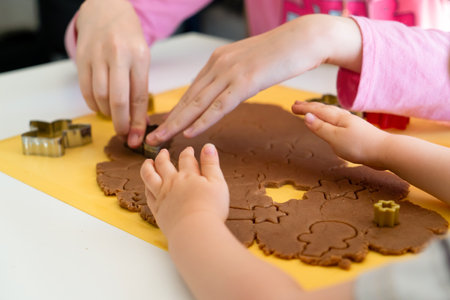 Kids making gingerbread cookies with various Christmas cookie cutters. Gingerbread dough. Family Christmas fun momentsの写真素材