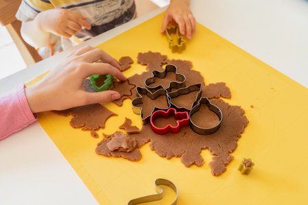 Kids making gingerbread cookies with various Christmas cookie cutters. Gingerbread dough. Family Christmas fun momentsの写真素材
