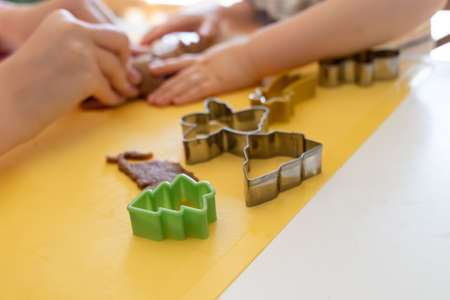 Kids making gingerbread cookies with various Christmas cookie cutters. Gingerbread dough. Family Christmas fun momentsの写真素材