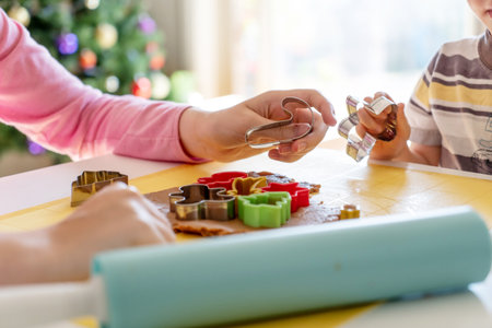 Kids making gingerbread cookies with various Christmas cookie cutters. Gingerbread dough. Family Christmas fun momentsの写真素材