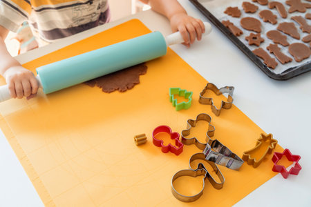 Kids making gingerbread cookies with various Christmas cookie cutters. Gingerbread dough. Family Christmas fun momentsの写真素材